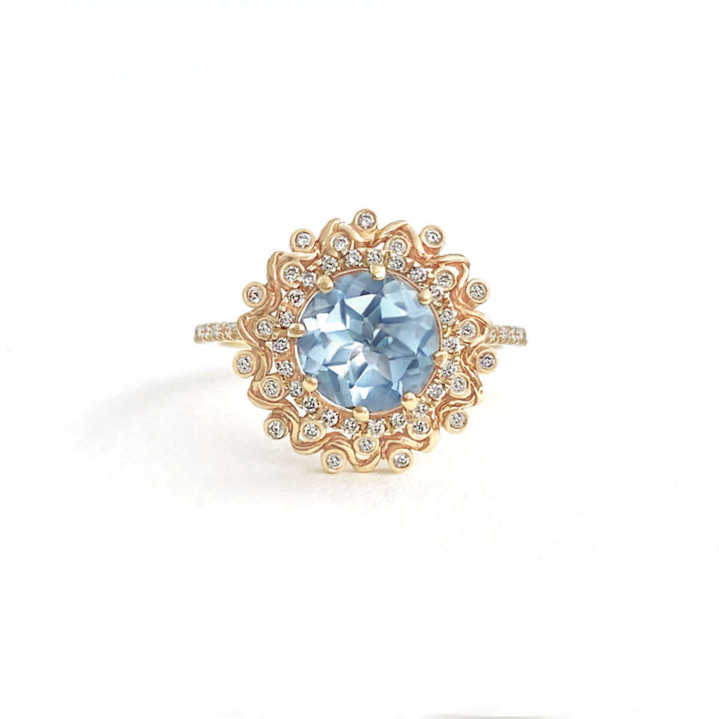 Soothing blue topaz ring wrapped with double halo set with 44 diamonds by JeweLyrie