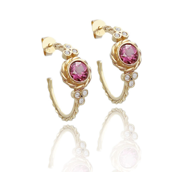 Lined twist earrings showcasing bezel set rhodolite garnet wrapped with signature twist and flanked with diamond trio clusters by JeweLyrie